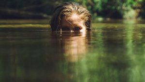 woman with head sticking up half-way out of water