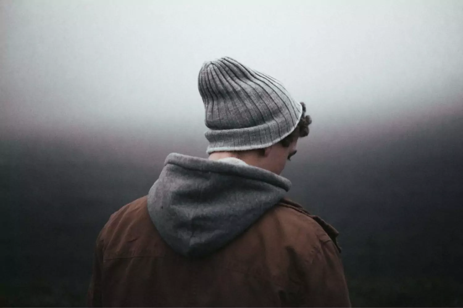 a man waiting in the fog