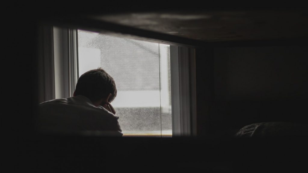 man sitting in dark room