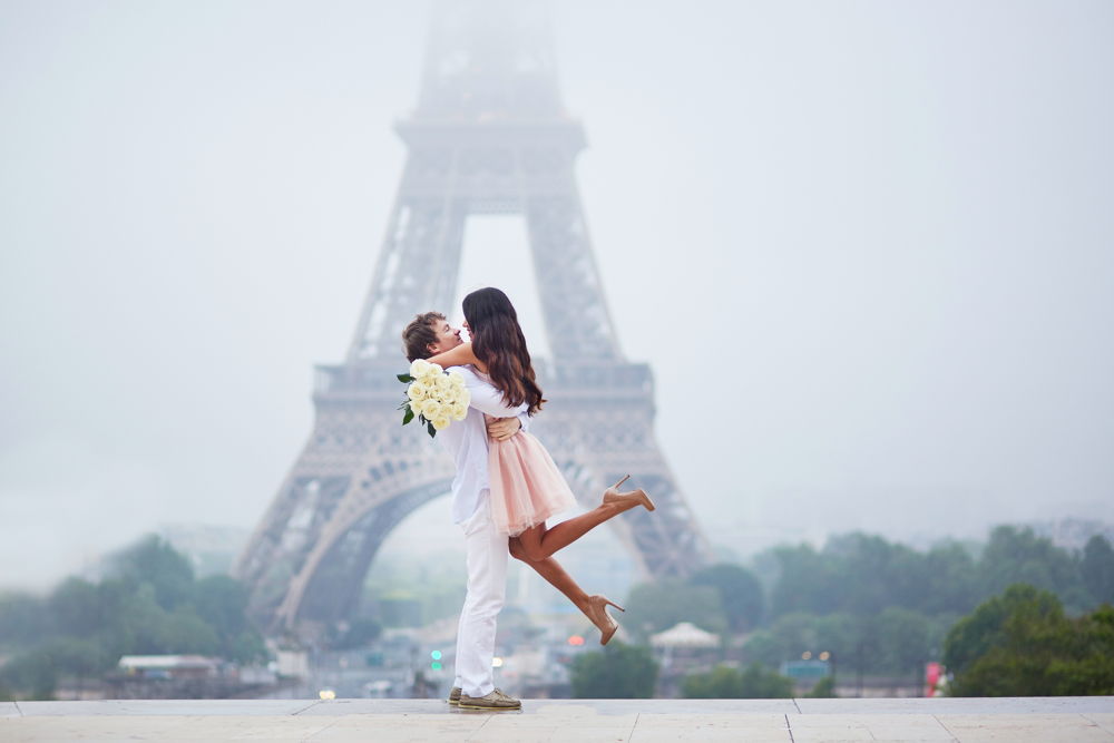 couple hugging in front of Eiffel Tower