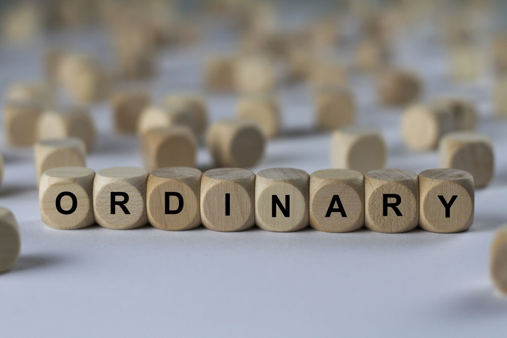 game pieces put together to spell "ordinary"