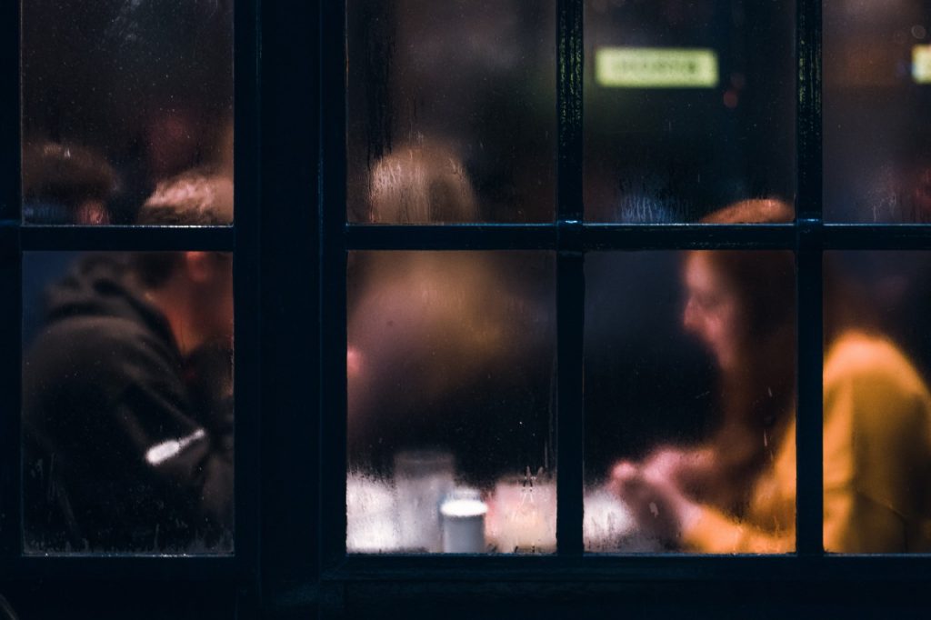 Couple behind foggy window at a cafe