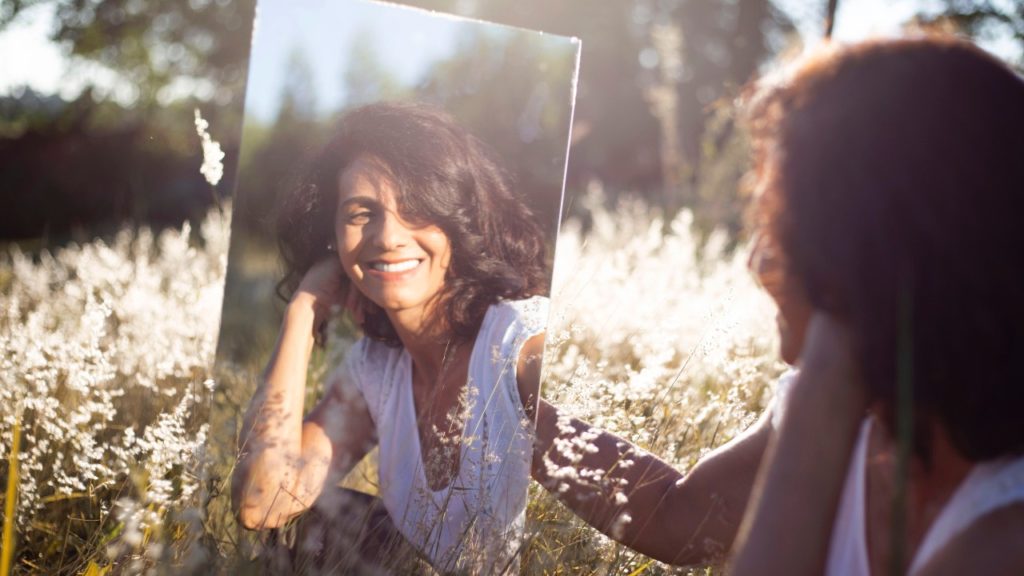 woman smiling in mirror