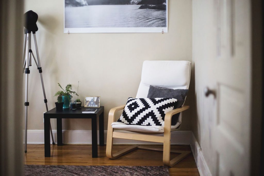 A cozy, modern space with an chair and side table.