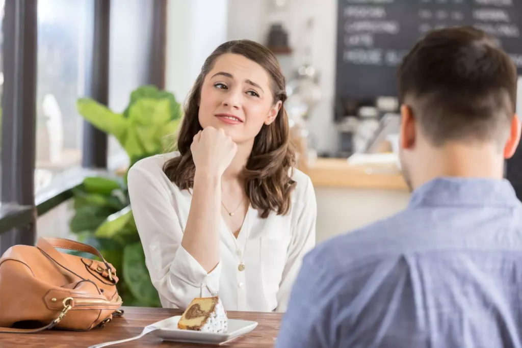 a woman and man on a date, the woman seems displeased and like there have been some dating mistakes