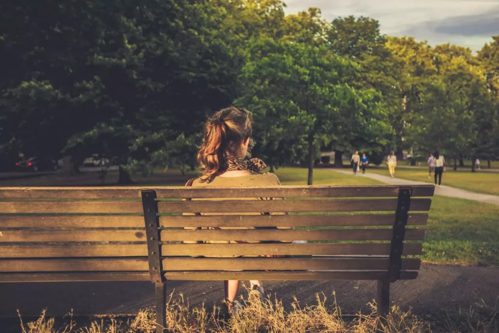 woman sitting on a park bench thinking about how broke she is and trusting the Lord to provide