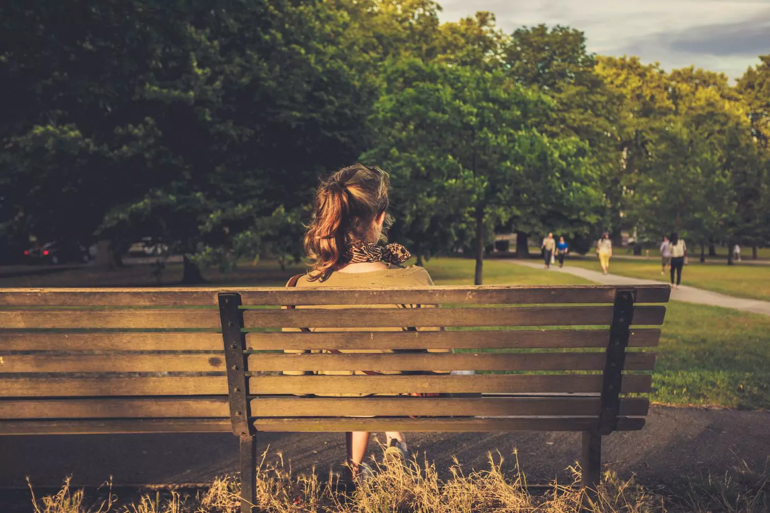 woman sitting on a park bench thinking about how broke she is and trusting the Lord to provide