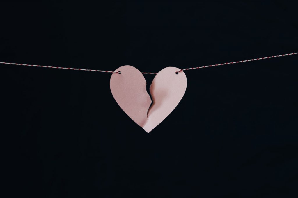 torn paper heart hanging from string