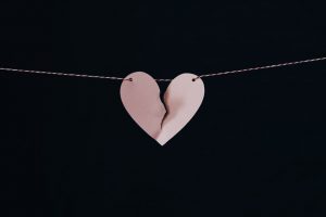 torn paper heart hanging from string