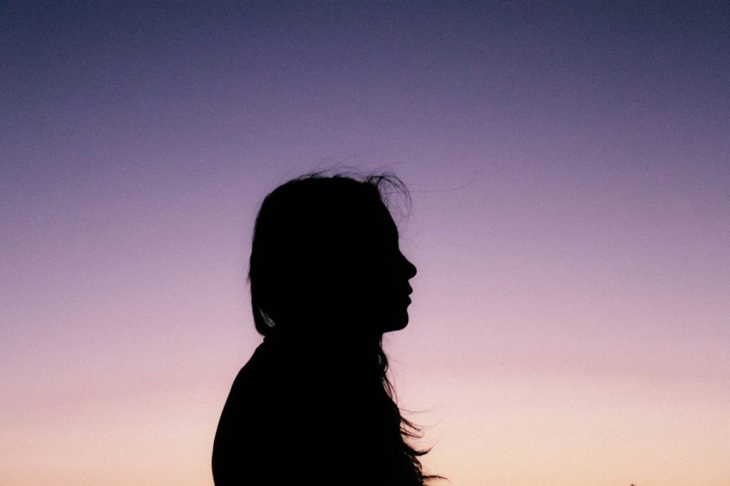 silhouette of girl staring into the skyi