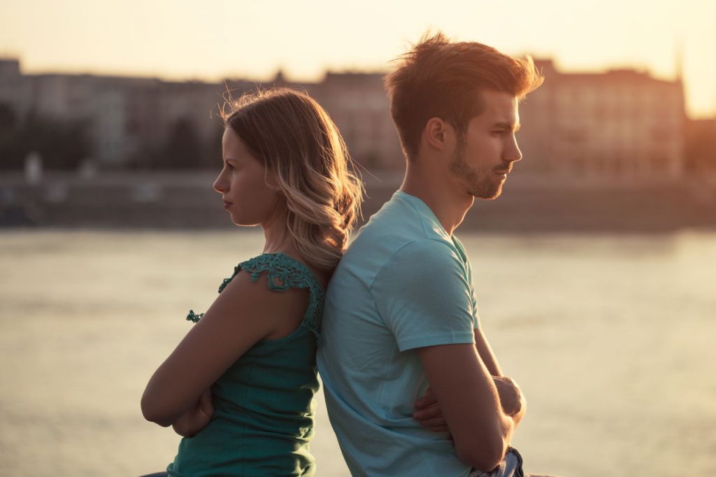 man and woman with backs to each other