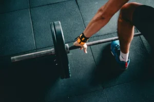 a man lifting weights, a symbol of using his ought muscles