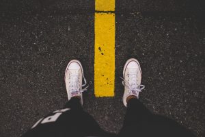 converse feet on asphalt street