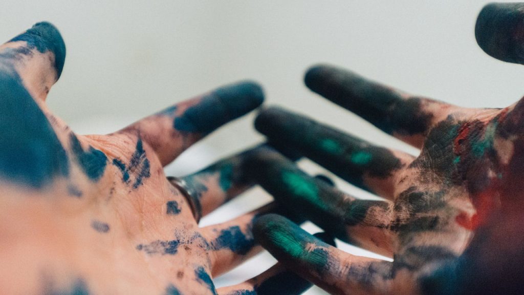 paint-stained hands held out