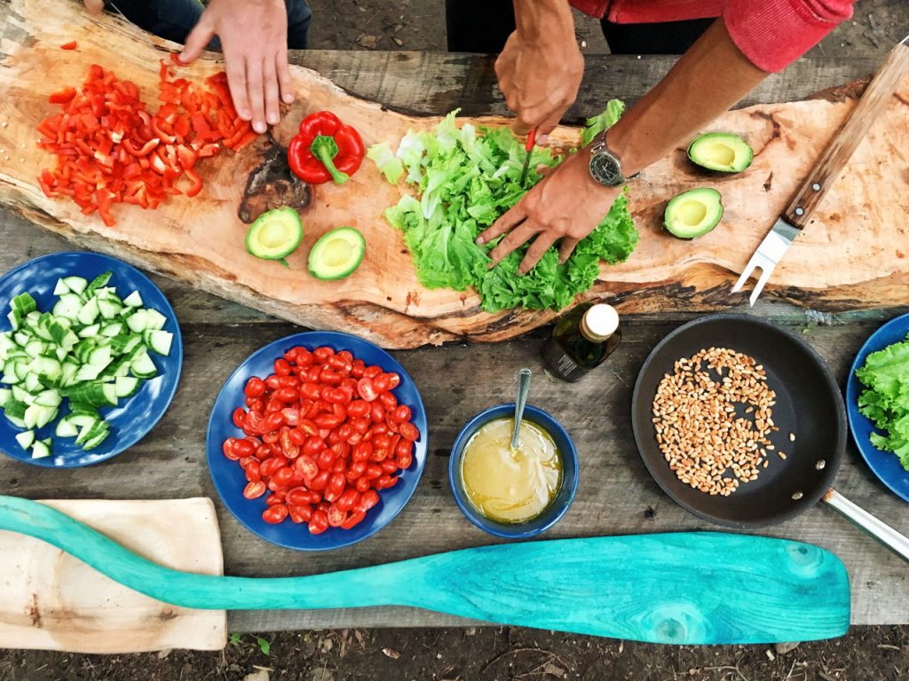 chopping lettuce, avocado, and other food