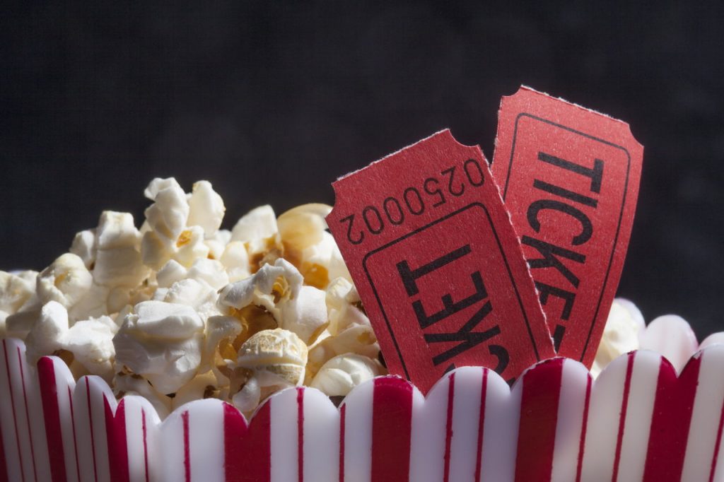 red popcorn box and movie theater tickets