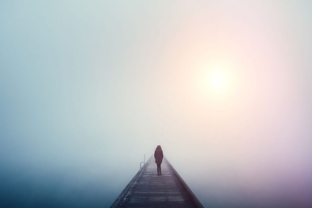 person standing alone on a bridge