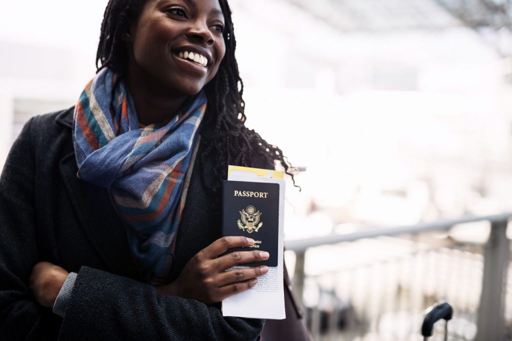 Young woman holding passport