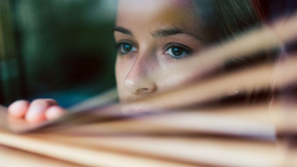 woman, afraid, scared, worried, looking out window