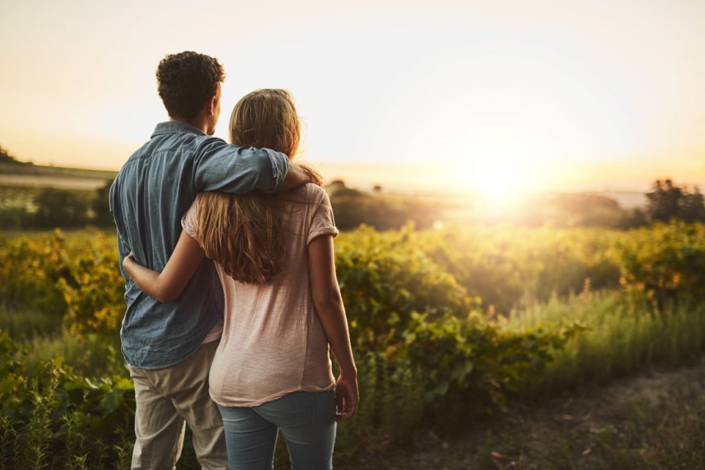 couple looking at the sunrise on the horizon