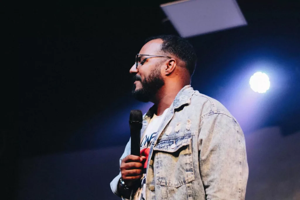 a pastor with a microphone, speaking