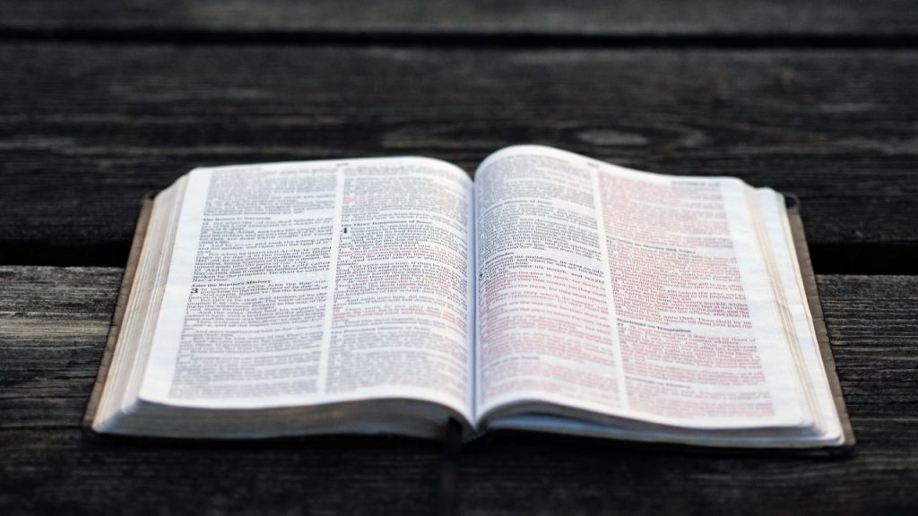 open Bible on wooden table