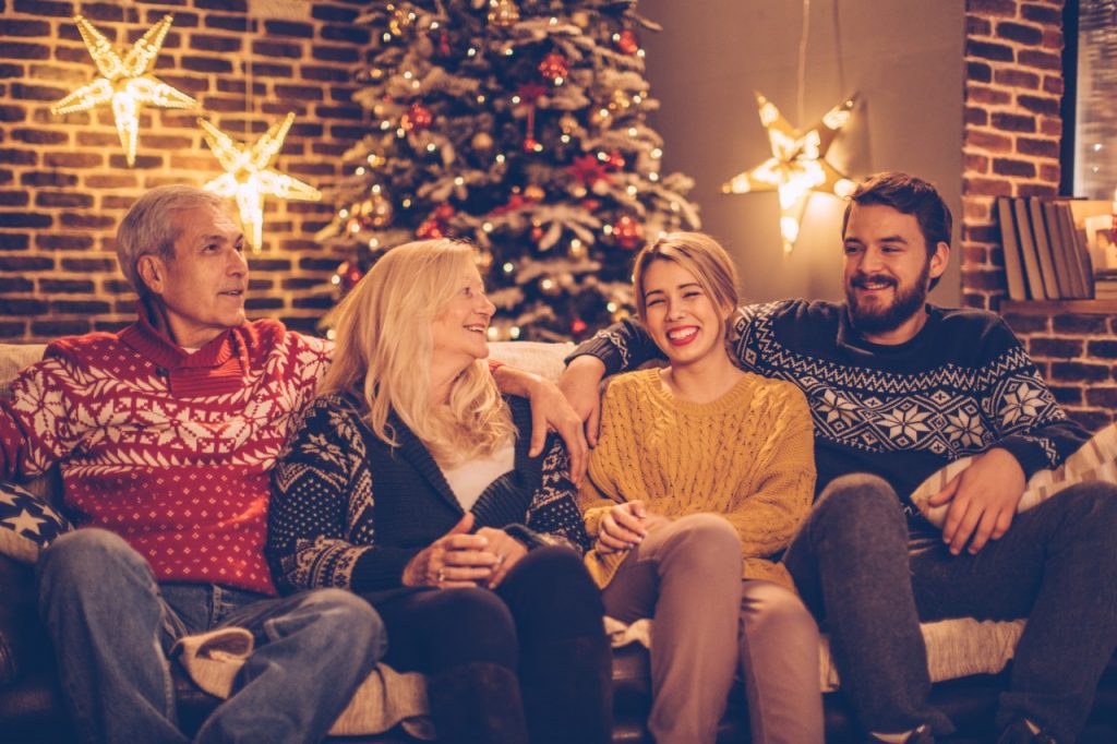 couple sitting on couch with parents