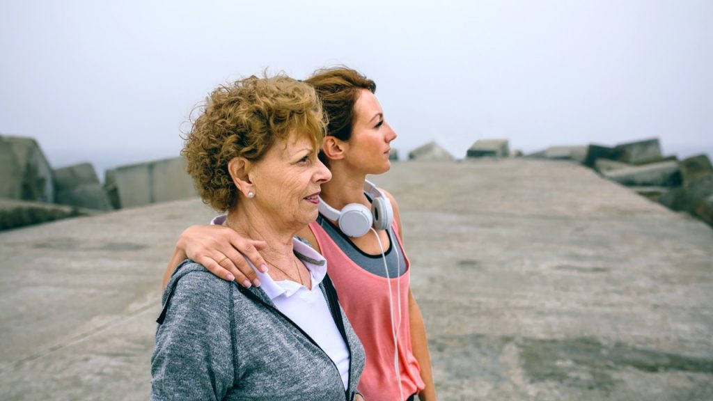 Elderly woman and young woman standing together