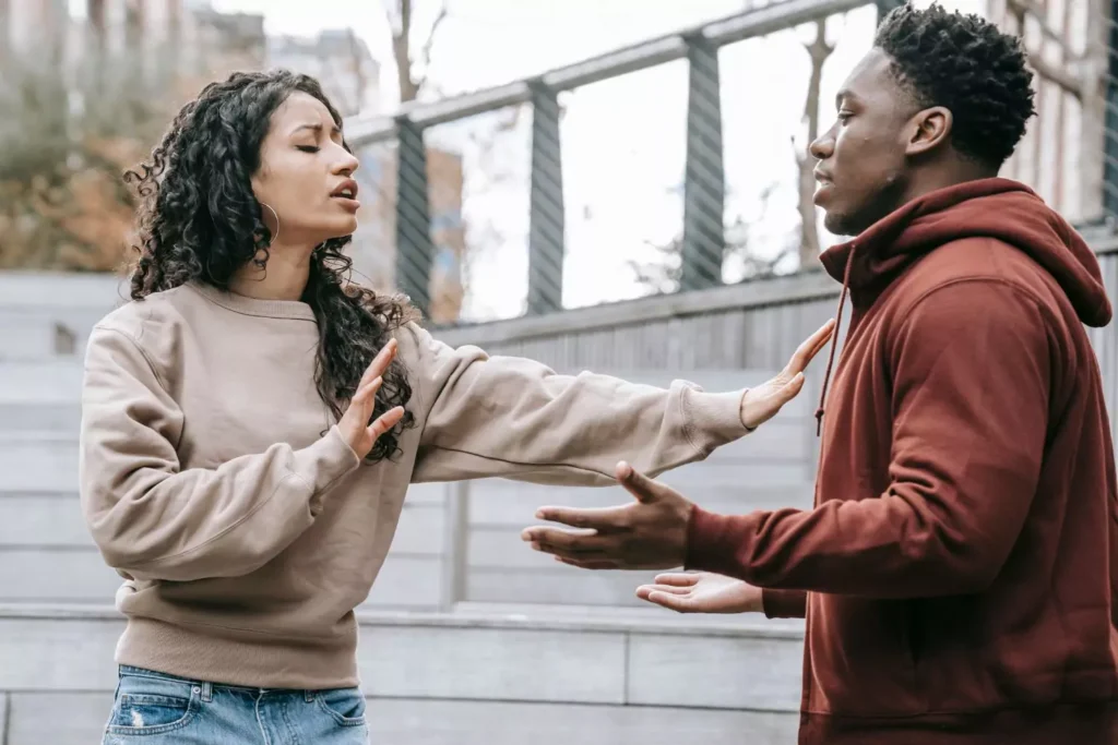 a woman and man in conflict with one another, arguing