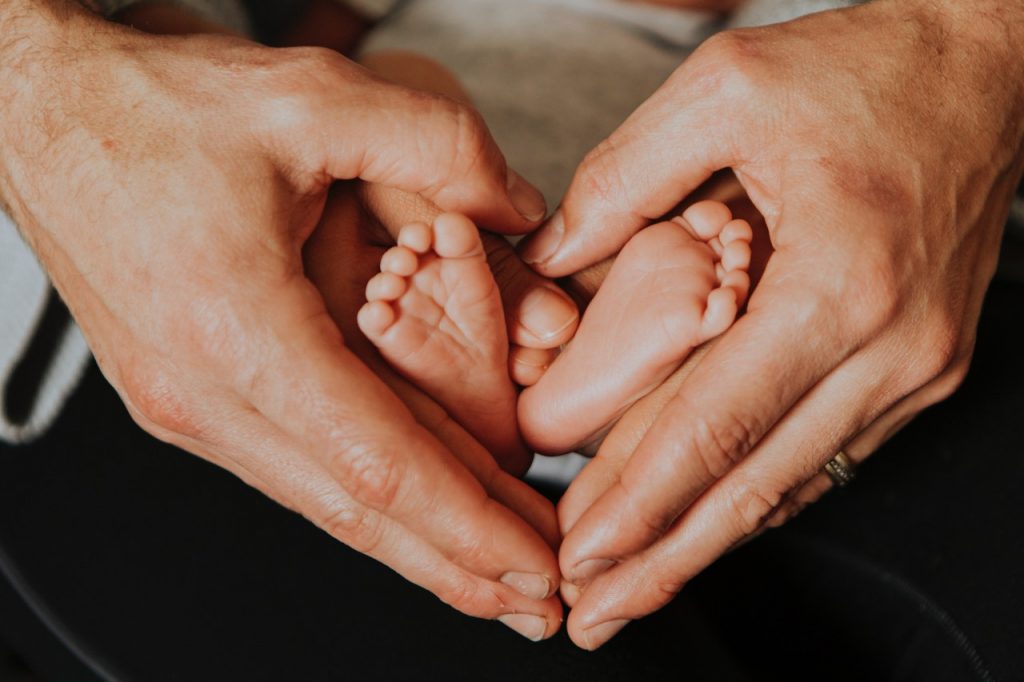 Hands around baby's feet