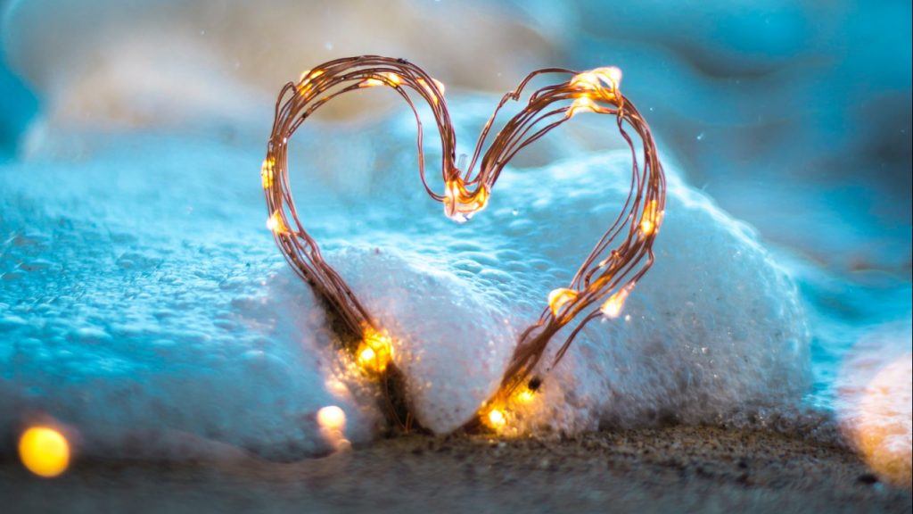 light string heart on beach