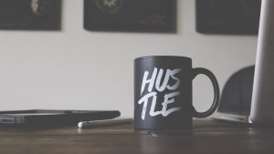 coffee cup with the word "hustle" on it