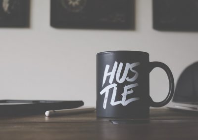 coffee cup with the word "hustle" on it