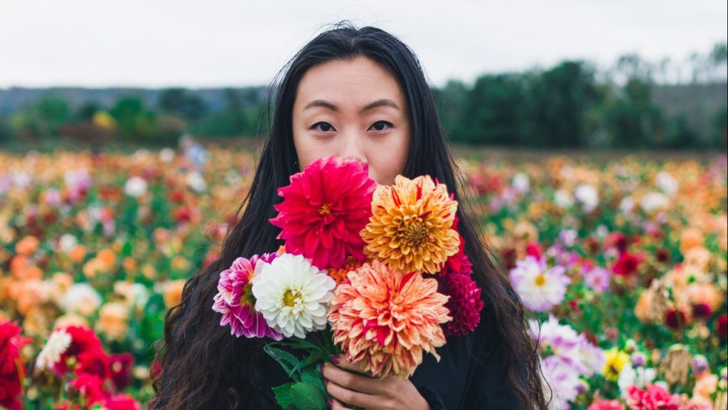 Woman holding flowers in a field