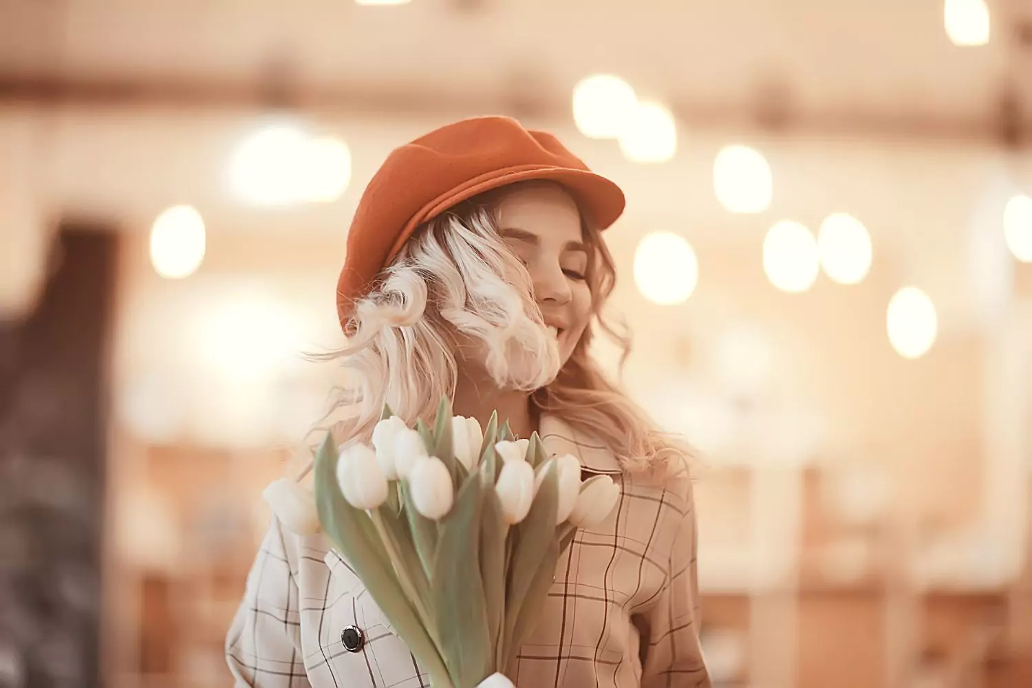 Woman in hat, holding white tulips - no need for productivity