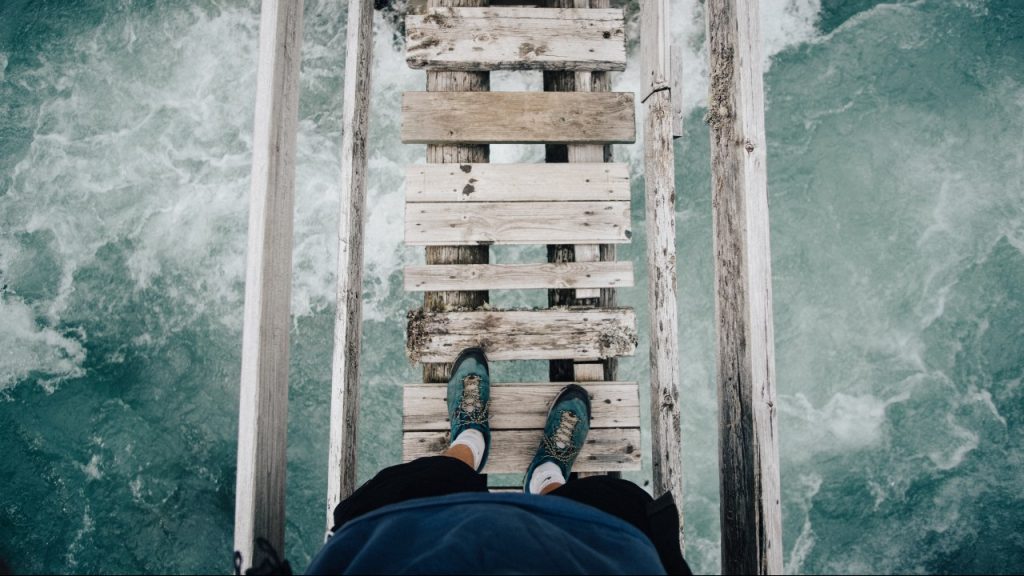 person walking on old bridge