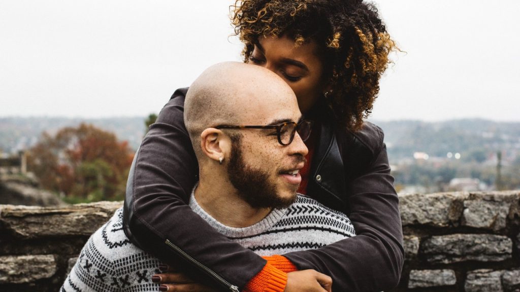 A couple, gathered together, hugging