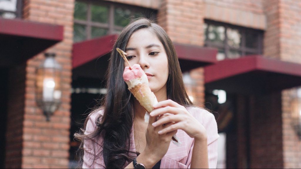 woman looking at ice cream cone