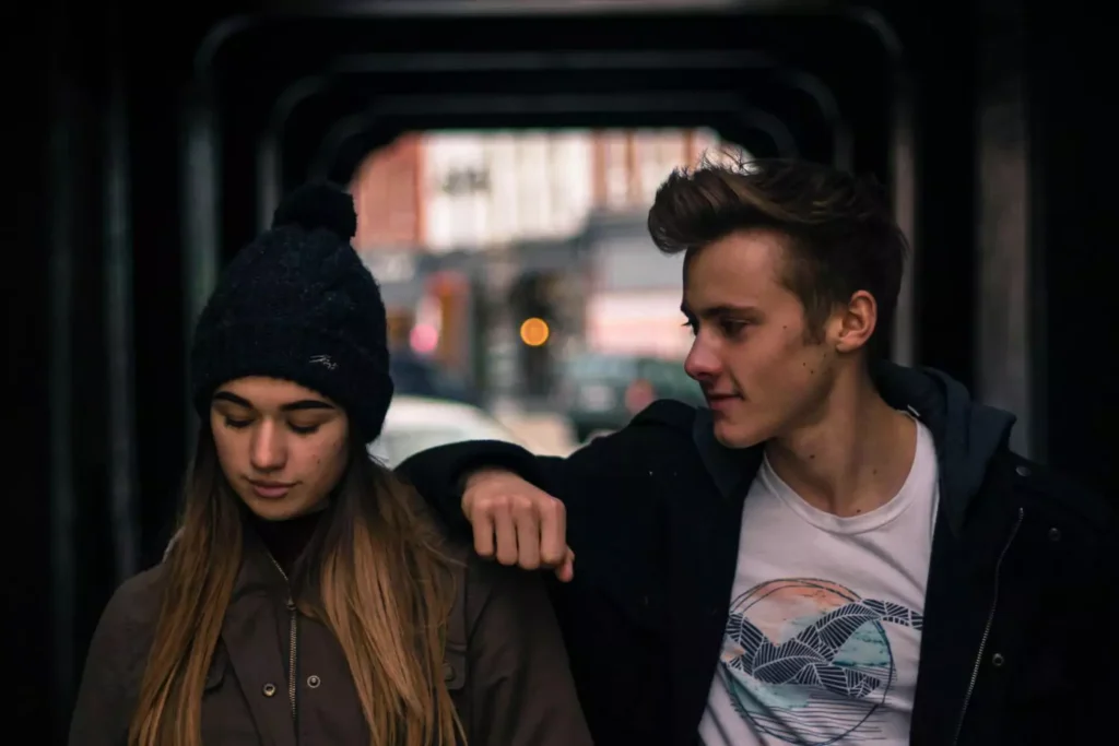 a woman and a man, relatively the same height, walking