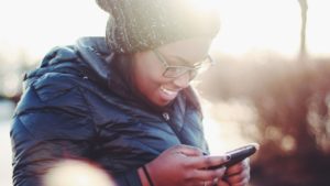 woman smiling looking at online dating app