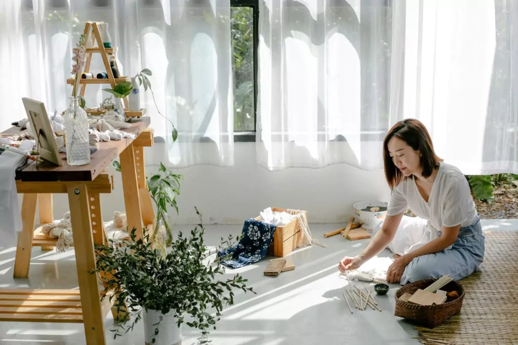 woman sitting on the ground doing art