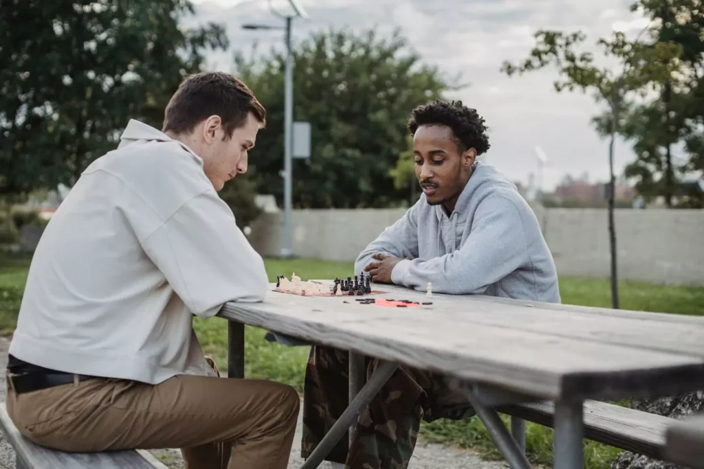 Two guys playing chess in a park. Neighbors.