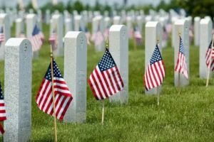 A military memorial park with flags at each tombstone for memorial day