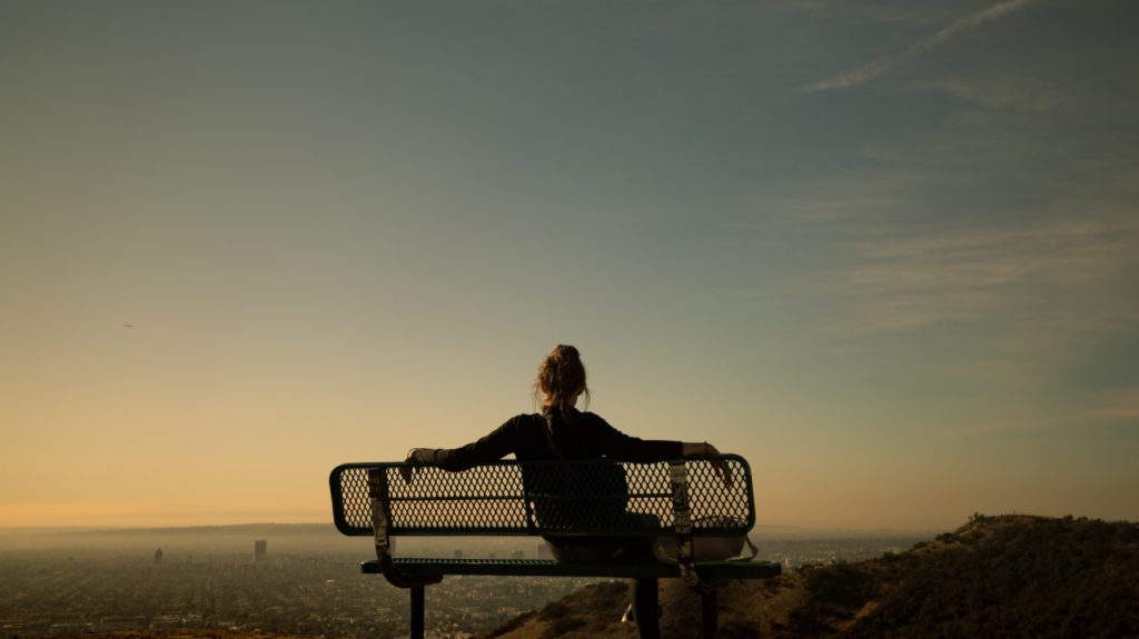 woman sitting alone on bench