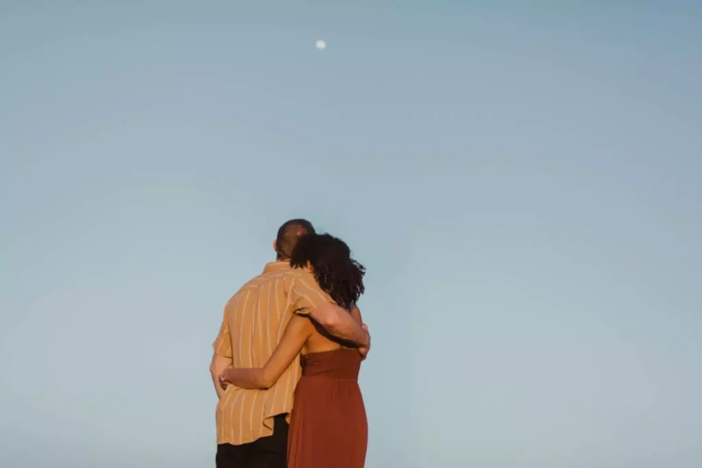a man and woman hugging, they are choosing attraction