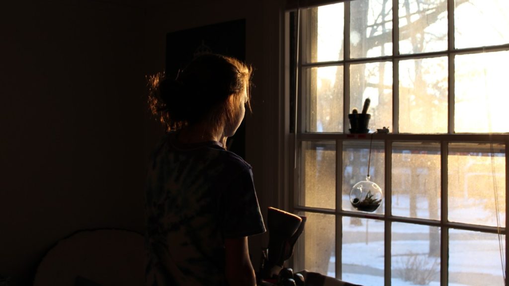 woman looking out window