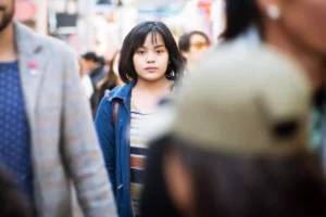 image focusing on one woman in a crowd, singled out