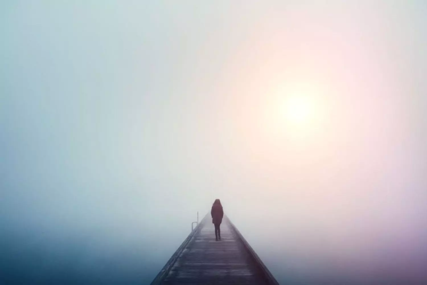 a suffering person walking alone in the fog