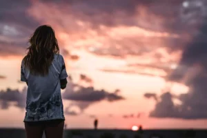 a woman looking at clouds, letting go of her sexual past