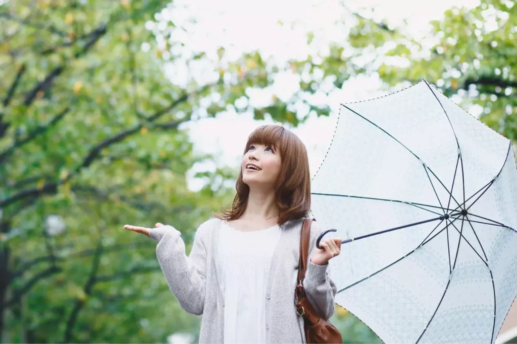 a woman holding an umbrella, she is single and still complete